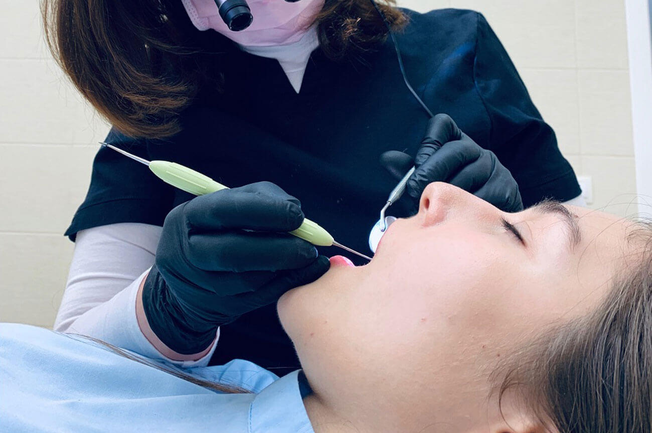 Dentist performs an operation on a patient under IV sedation